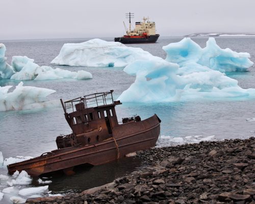 Ship,Wreck,On,Arctic,Coast,With,Icebergs,And,Icebreaker,On